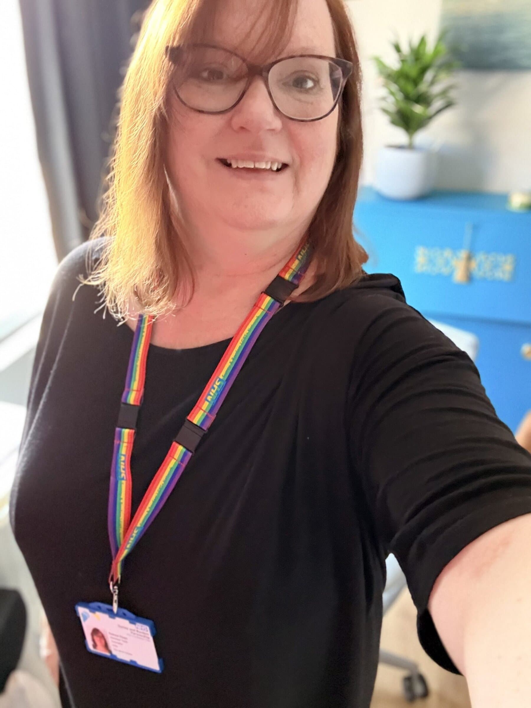 Yvonne wearing NHS rainbow lanyard